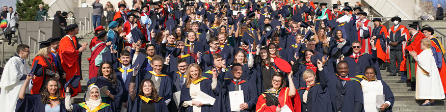 graduates line up in front of liverpool metropolitan cathedral